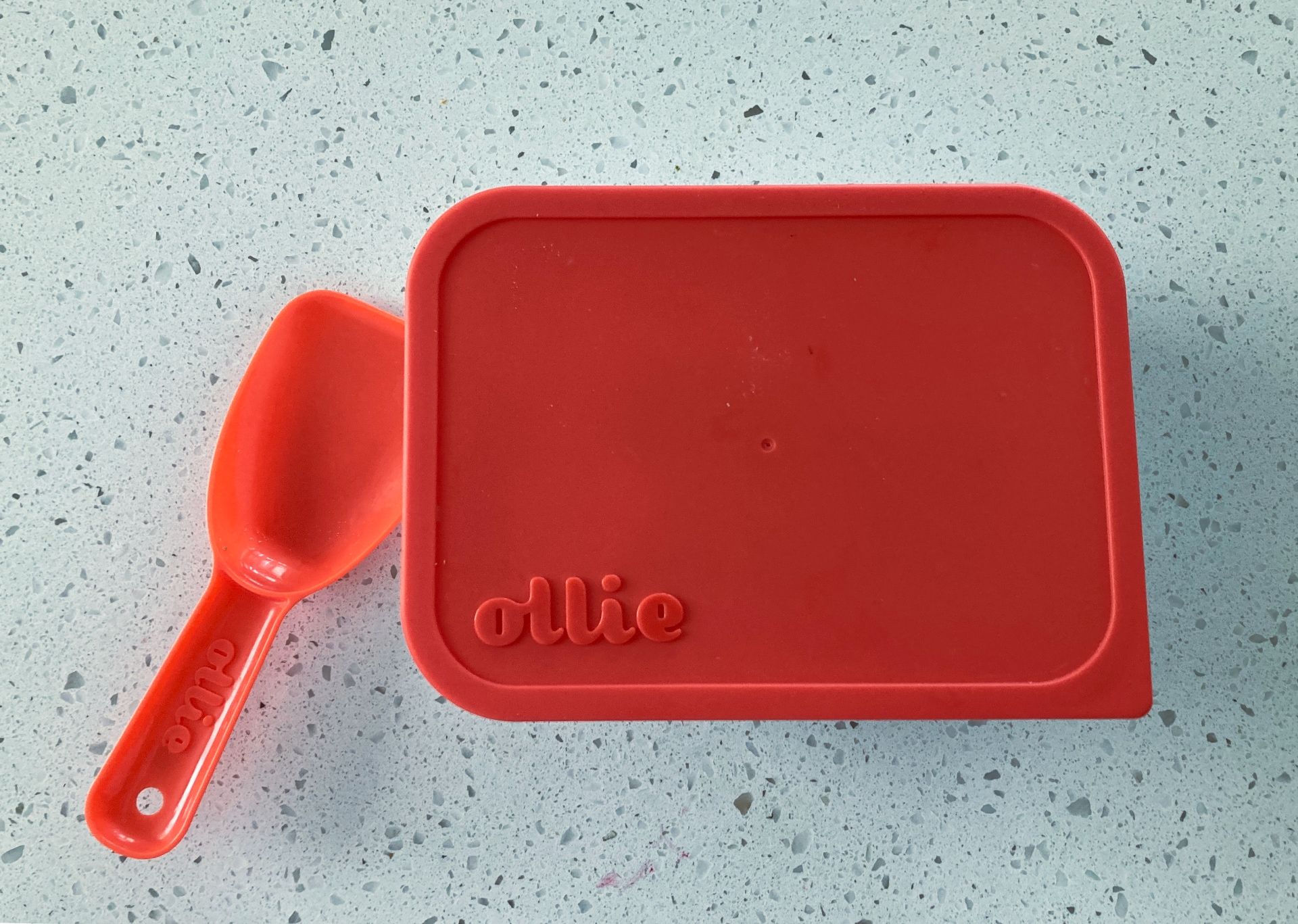 The handy plastic container and scoop included with Ollie dog food delivery.